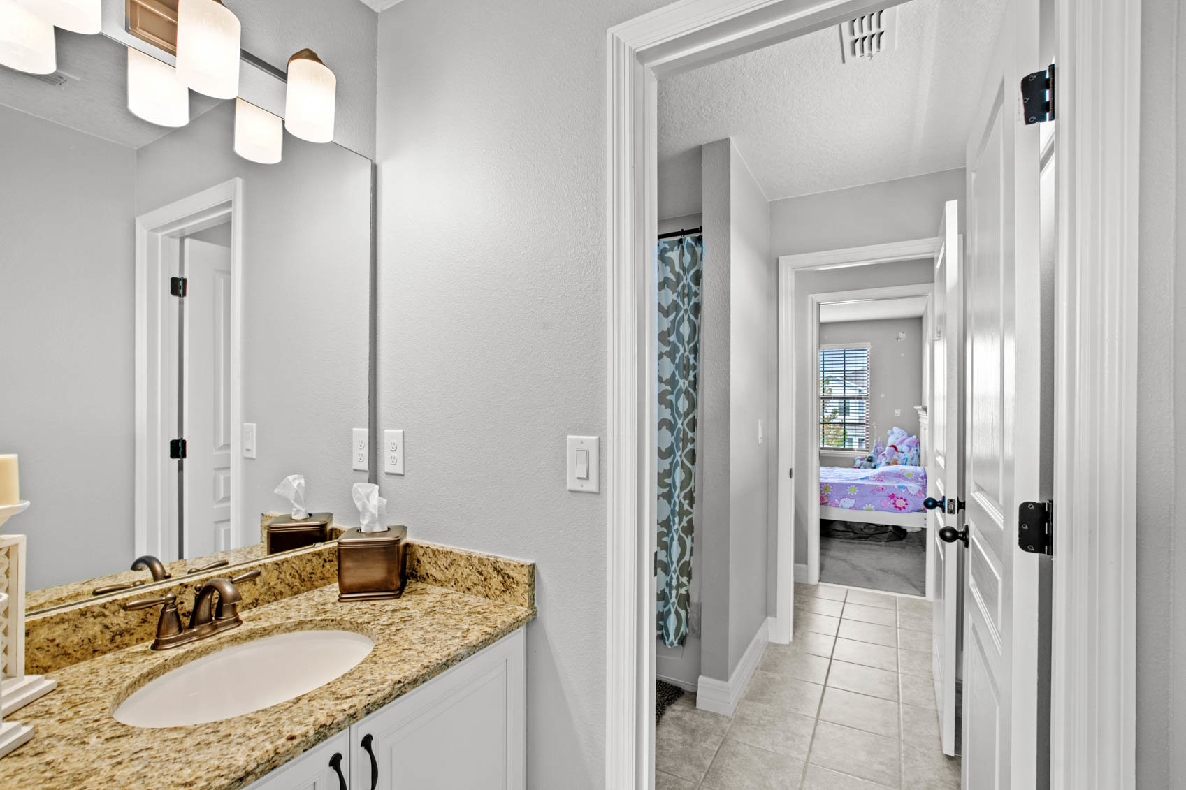 bathroom with personal sink and door looking into other bedroom
